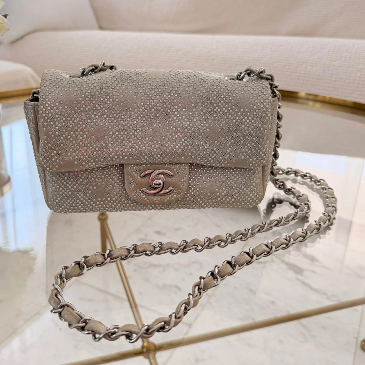 Chanel iridescent studded calfskin Mini Flap crossbody bag, with a chain strap and silver hardware available in Cyprus at HOUSE of MICY