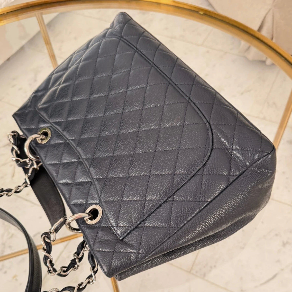 Back pocket of a Chanel Caviar Grand Shopping Tote bag, blue caviar leather, with chain handles, silver hardware available in Cyprus at HOUSE of MICY