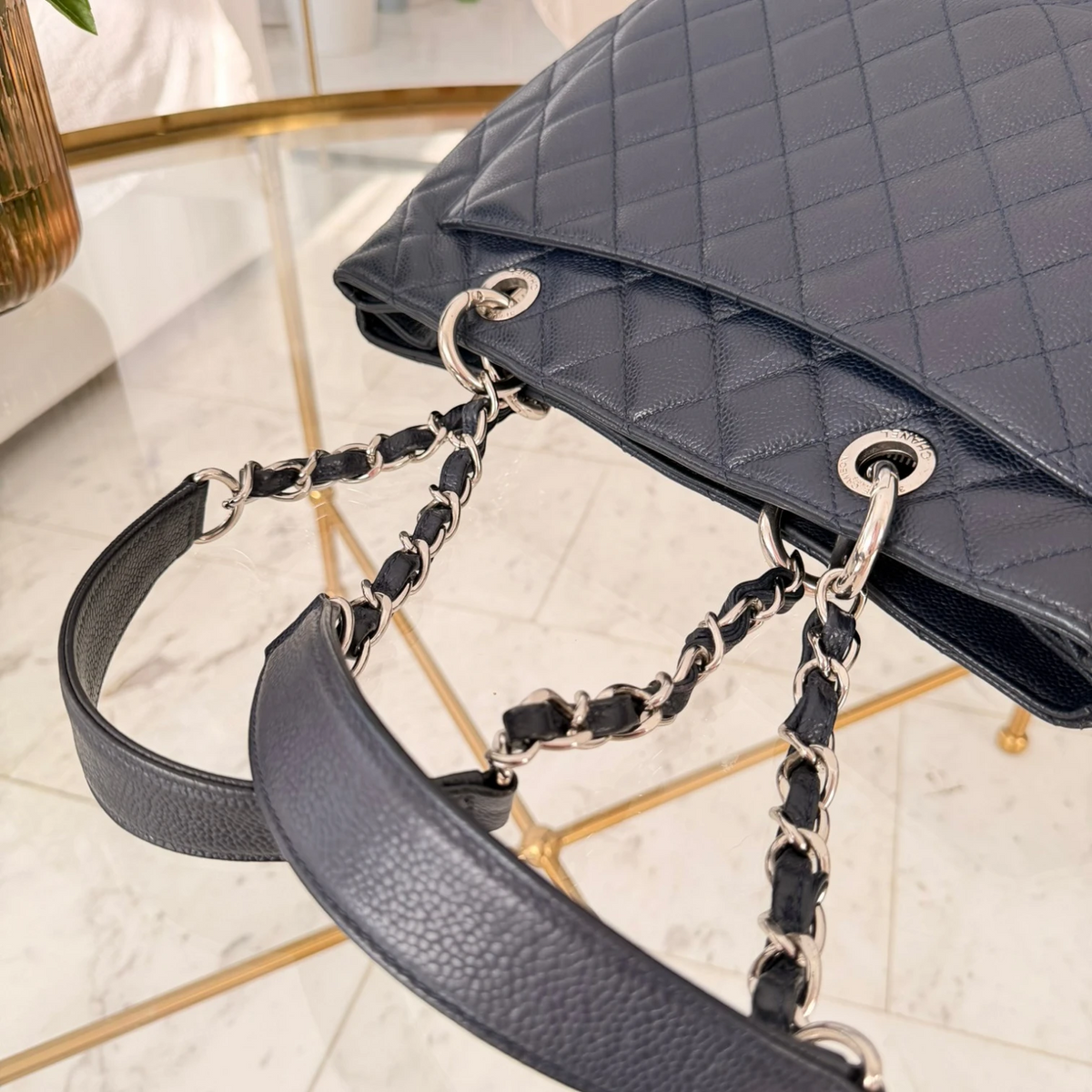 Back pocket and handles of a Chanel Caviar Grand Shopping Tote bag, blue caviar leather, with chain handles, silver hardware available in Cyprus at HOUSE of MICY