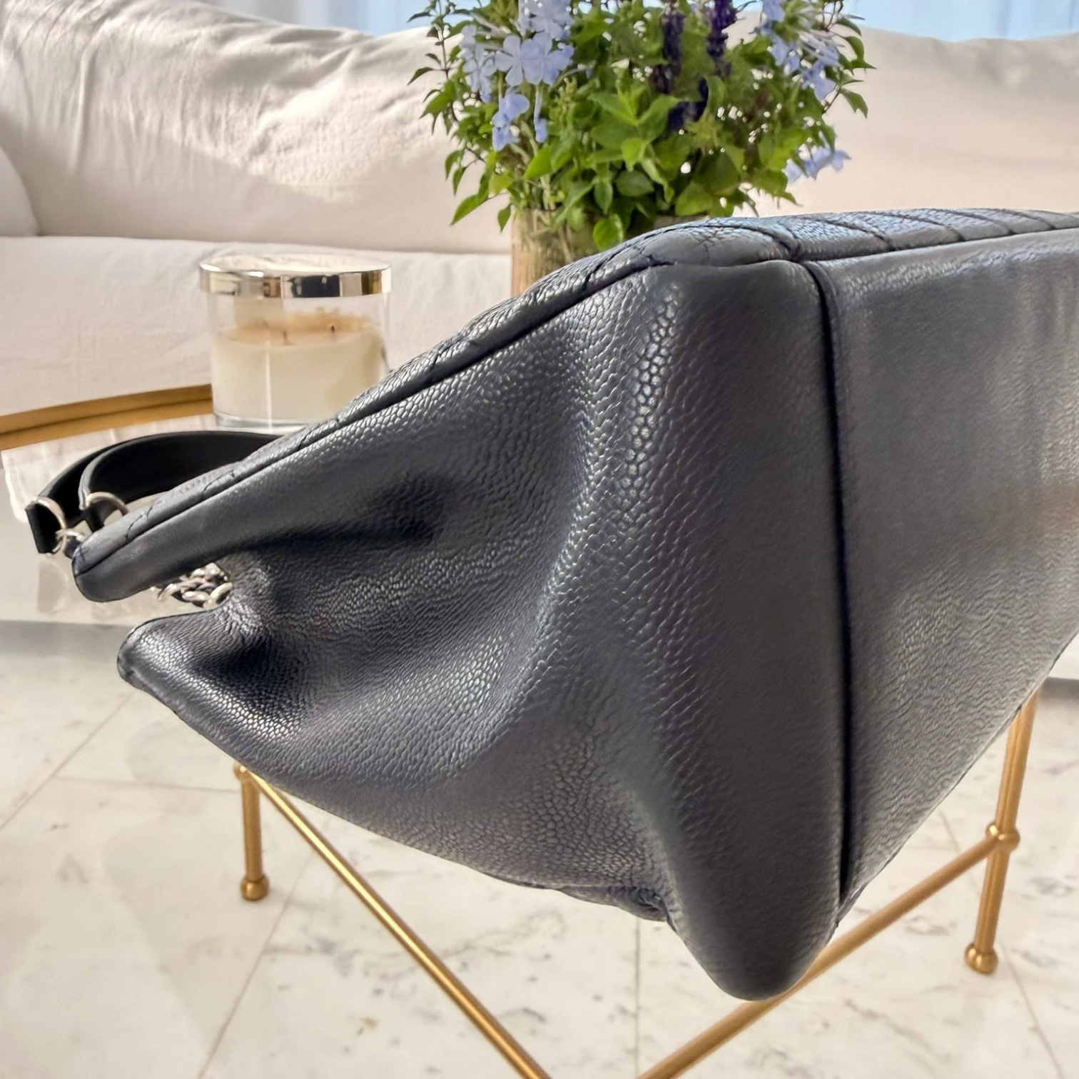 Side view of a CC Chanel Caviar Grand Shopping Tote bag, blue caviar leather, with  chain handles, silver hardware available in Cyprus at HOUSE of MICY
