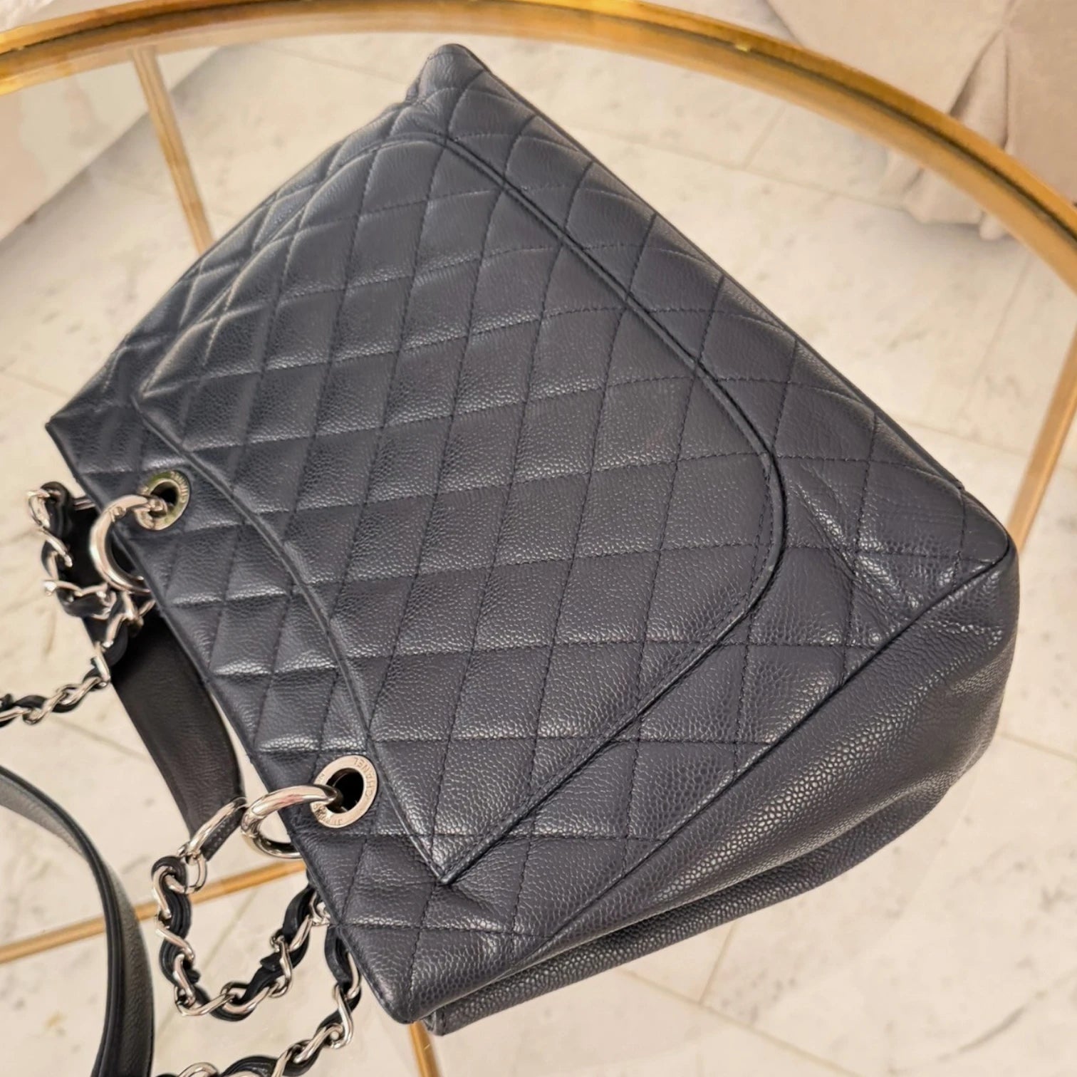 Back pocket of a Chanel Caviar Grand Shopping Tote bag, blue caviar leather, with chain handles, silver hardware available in Cyprus at HOUSE of MICY