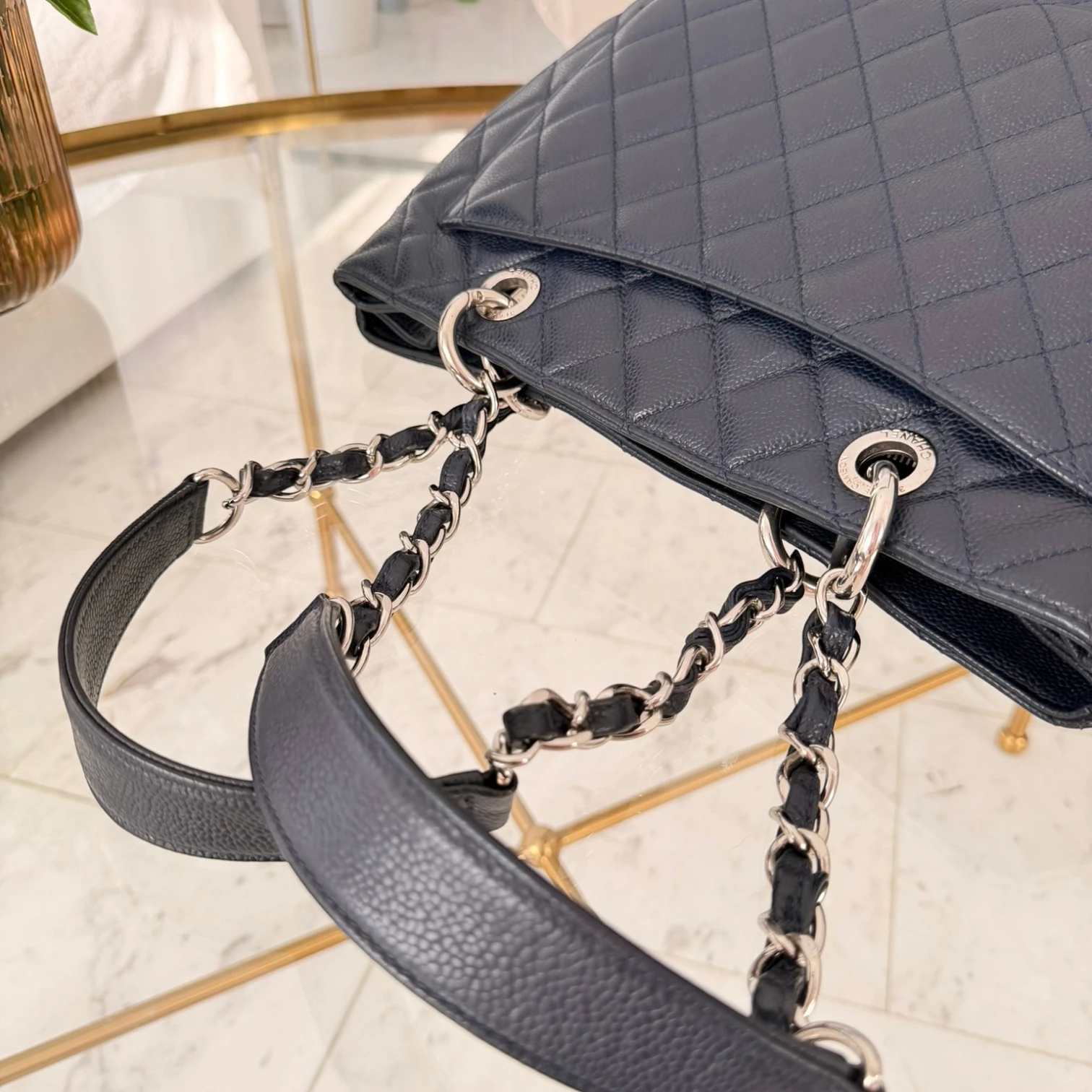 Back pocket and handles of a Chanel Caviar Grand Shopping Tote bag, blue caviar leather, with chain handles, silver hardware available in Cyprus at HOUSE of MICY