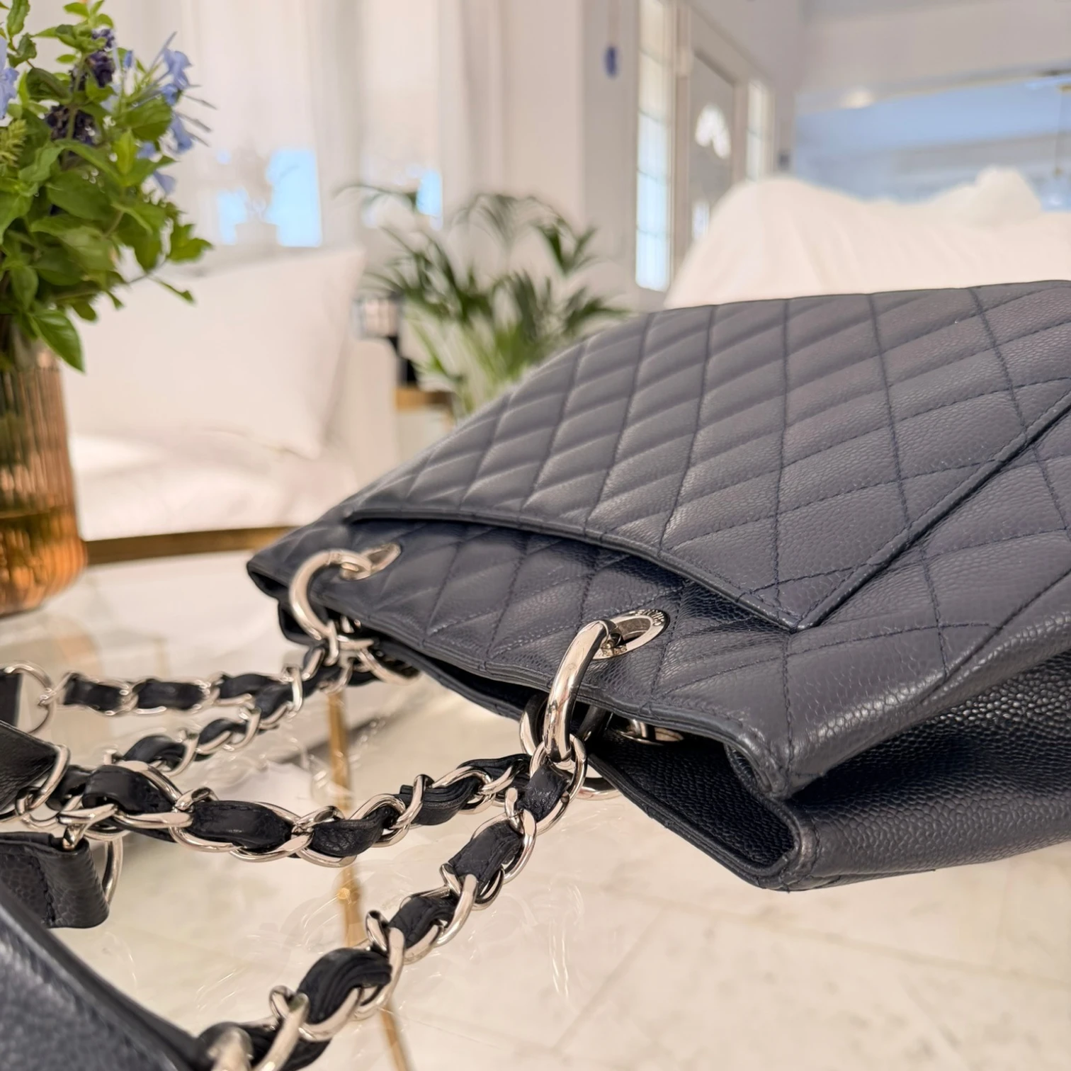 Back pocket and handles of a Chanel Caviar Grand Shopping Tote bag, blue caviar leather, with chain handles, silver hardware available in Cyprus at HOUSE of MICY